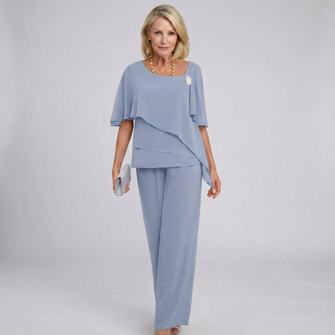 Woman wearing a light blue outfit with a plain background