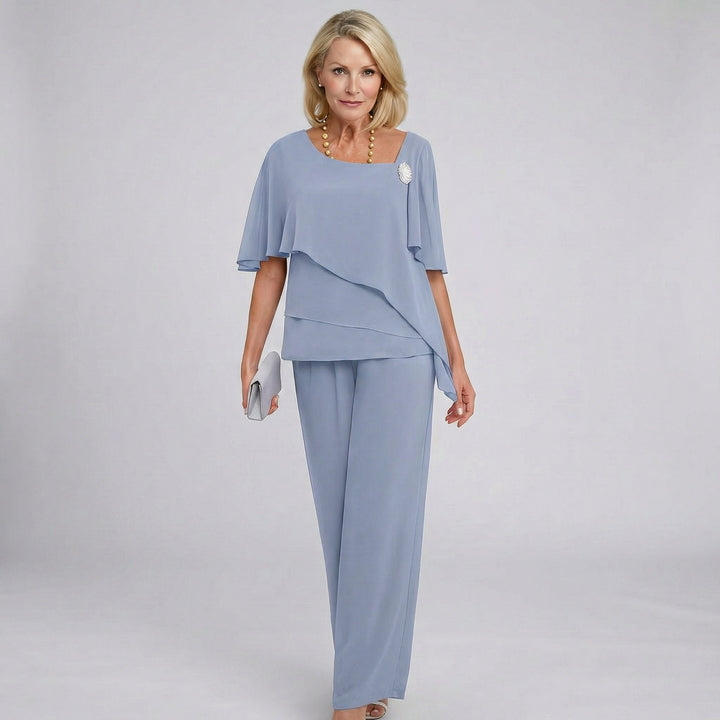 Woman wearing a light blue outfit with a plain background