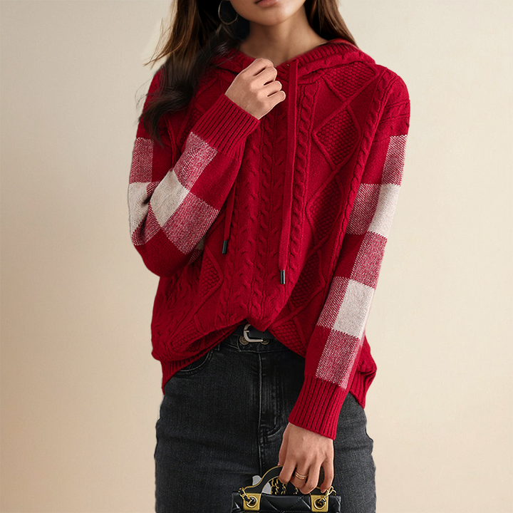 Red and white checkered sweater worn by a person on a beige background