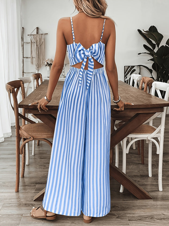 Woman wearing a blue and white striped dress in a dining room.