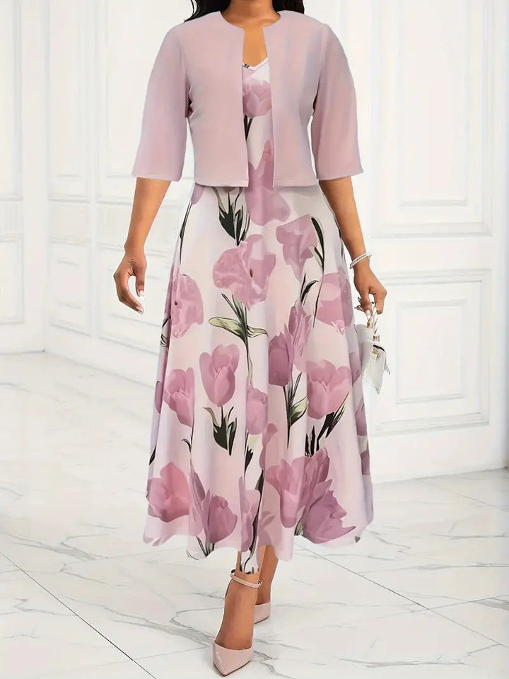 Woman wearing a floral dress with a matching jacket in a minimalistic setting