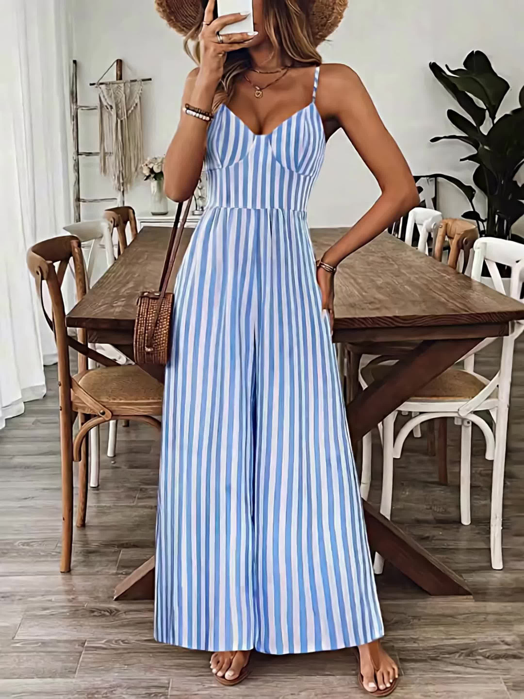 Woman in a blue and white striped dress standing in a dining room.