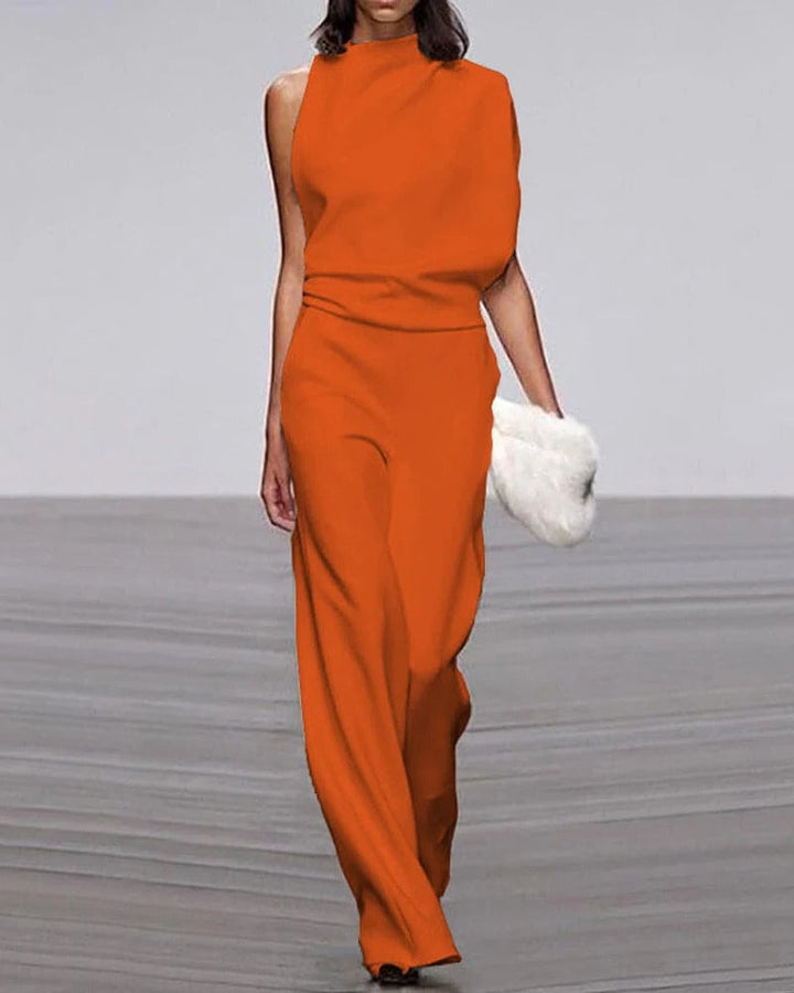 Person wearing an orange jumpsuit on a plain background