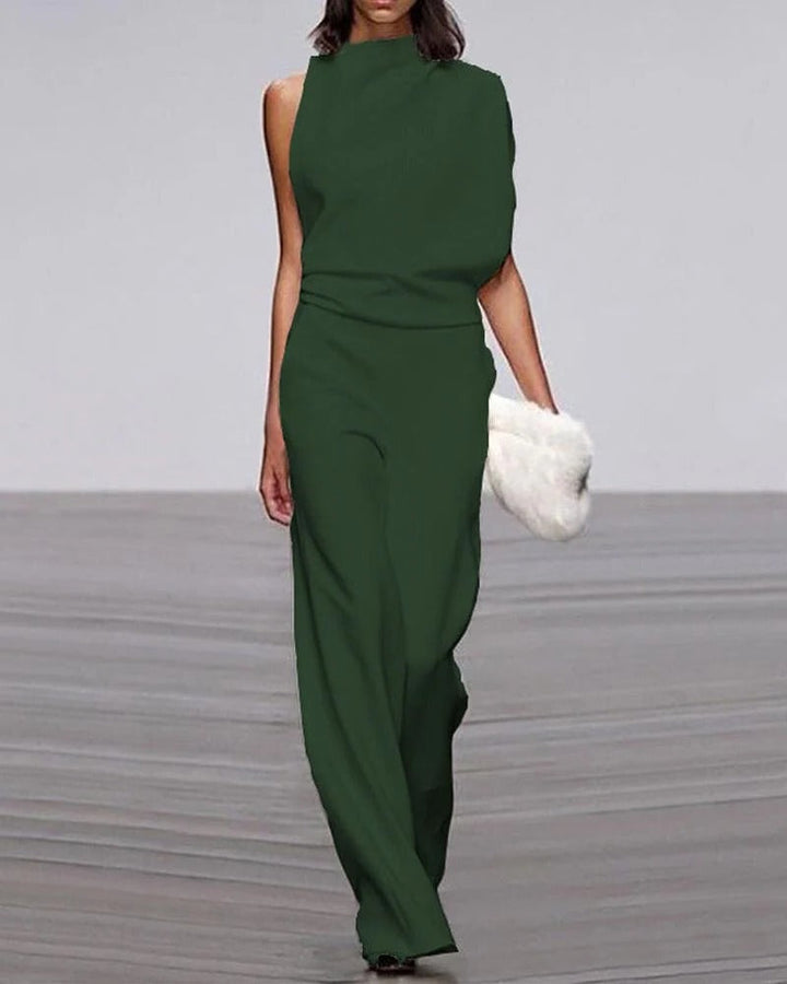 Green jumpsuit worn by a model on a plain background