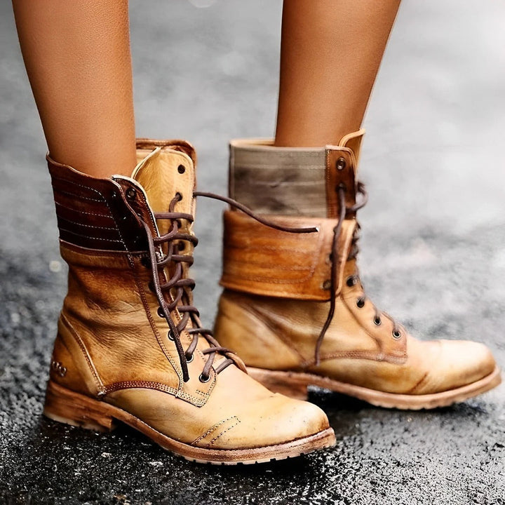 Brown leather boots on a gray pavement background