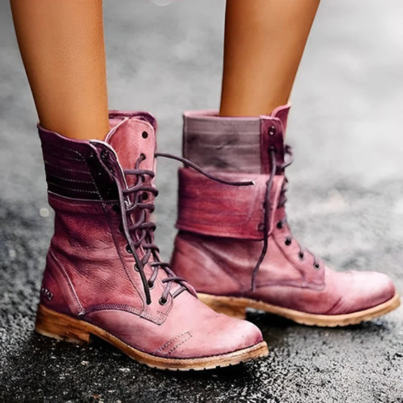Pink leather boots on a gray pavement background