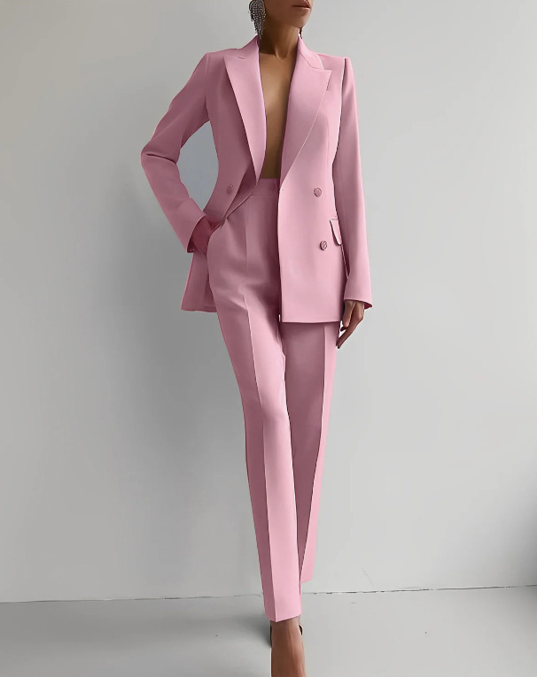 Pink suit worn by a person against a plain background