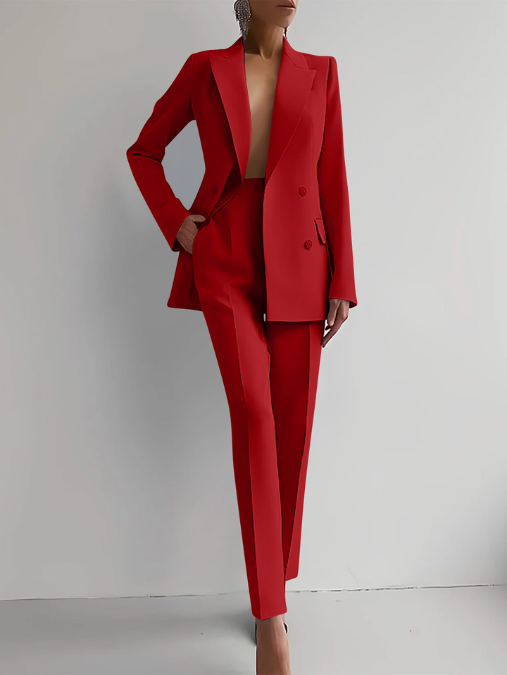 Red suit worn by a person on a plain background