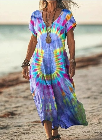 Person wearing a tie-dye dress on a beach