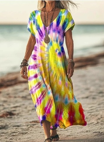 Person wearing a tie-dye dress on a beach