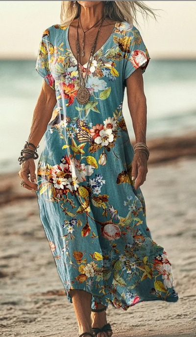 Woman wearing a colorful floral dress on a beach