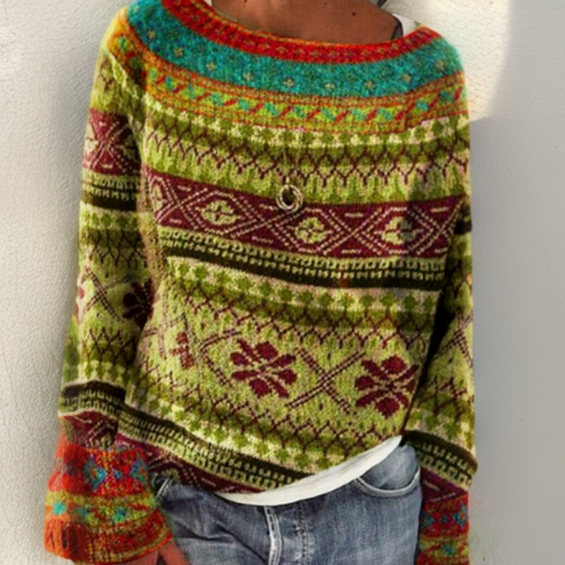 Colorful patterned sweater worn by a person on a plain background