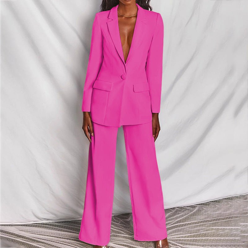 Person wearing a bright pink suit against a plain background