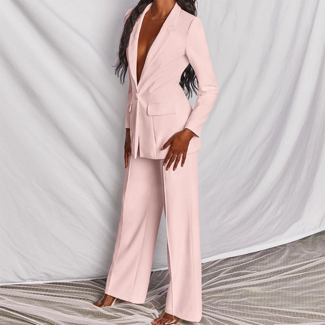 Person wearing a light pink suit against a neutral background