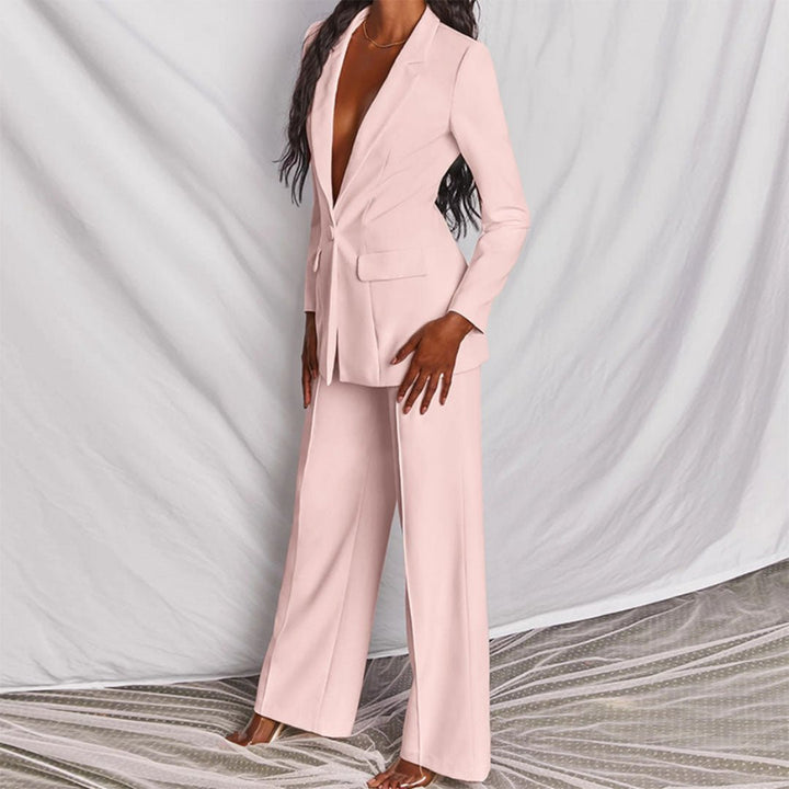 Person wearing a light pink suit against a neutral background