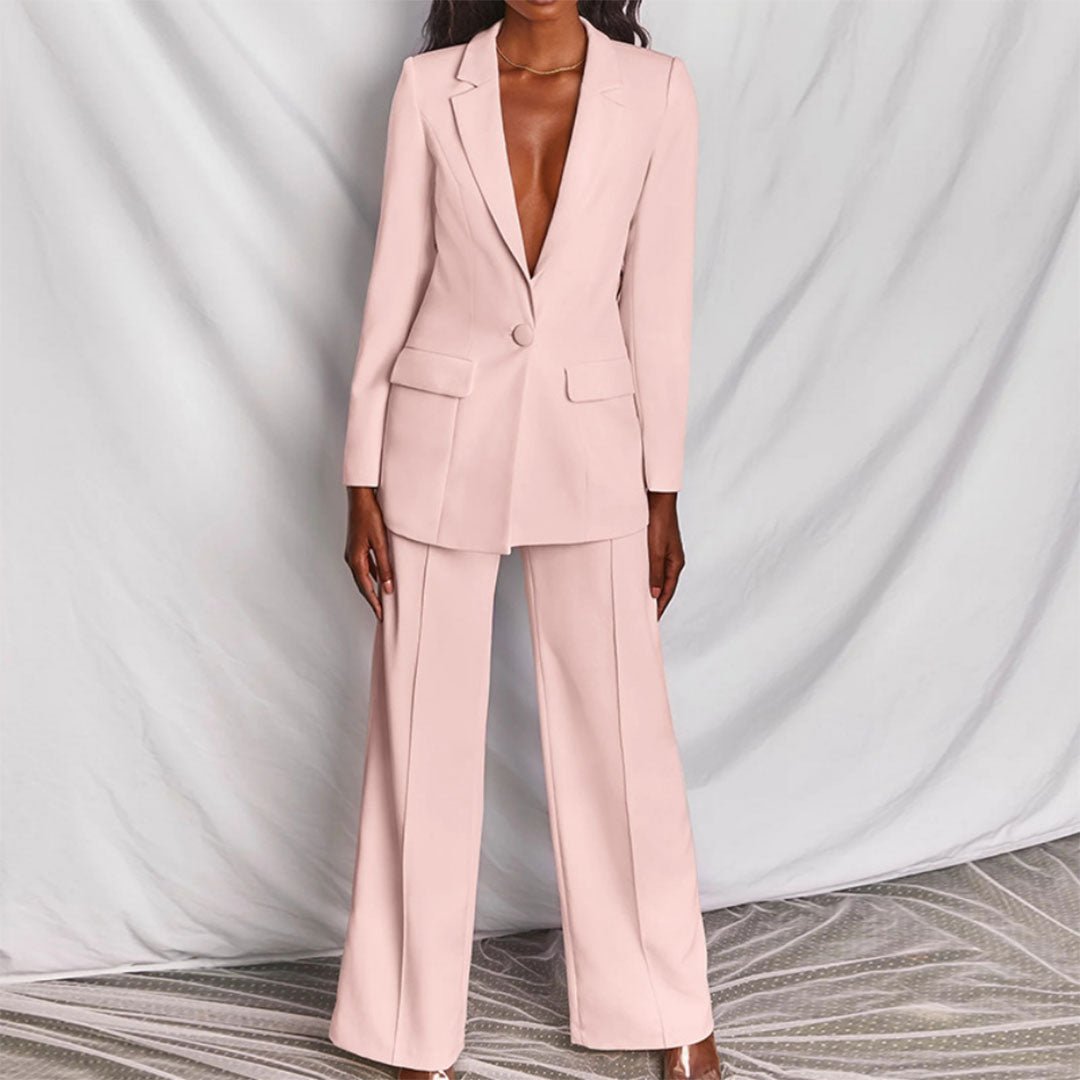 Pink suit worn by a model against a plain background