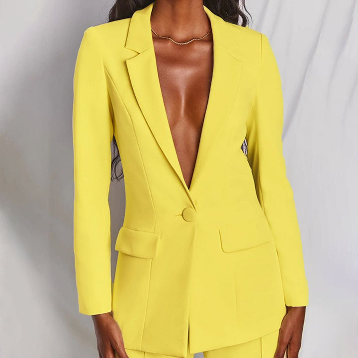 Yellow suit jacket worn by a person on a plain background