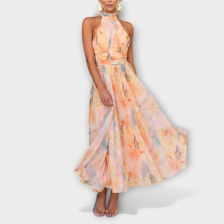 Woman wearing a floral halter neck dress on a white background
