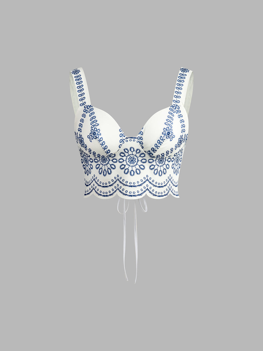 White bra with blue lace detailing on a gray background
