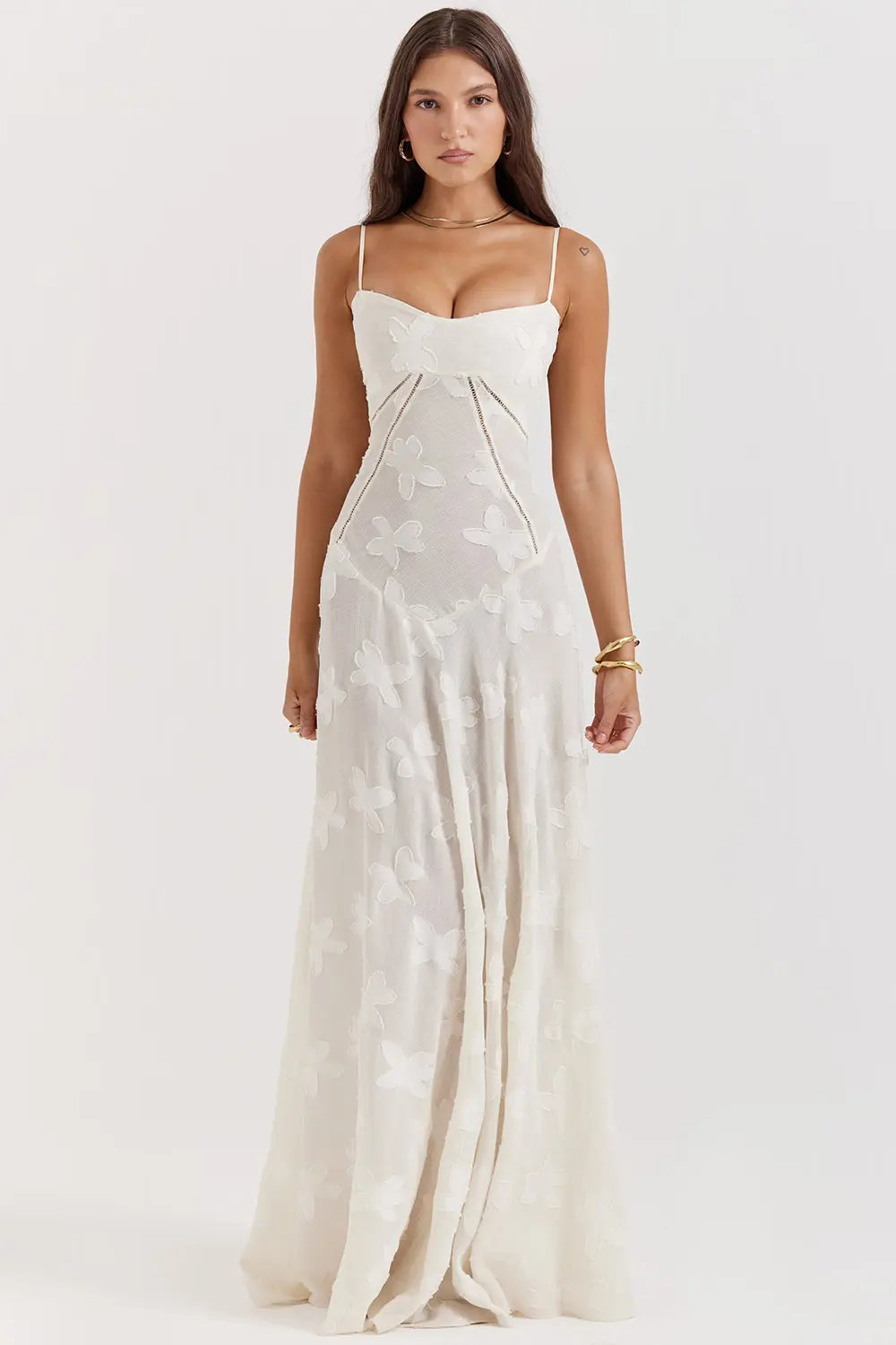 Woman wearing a white strapless gown on a white background