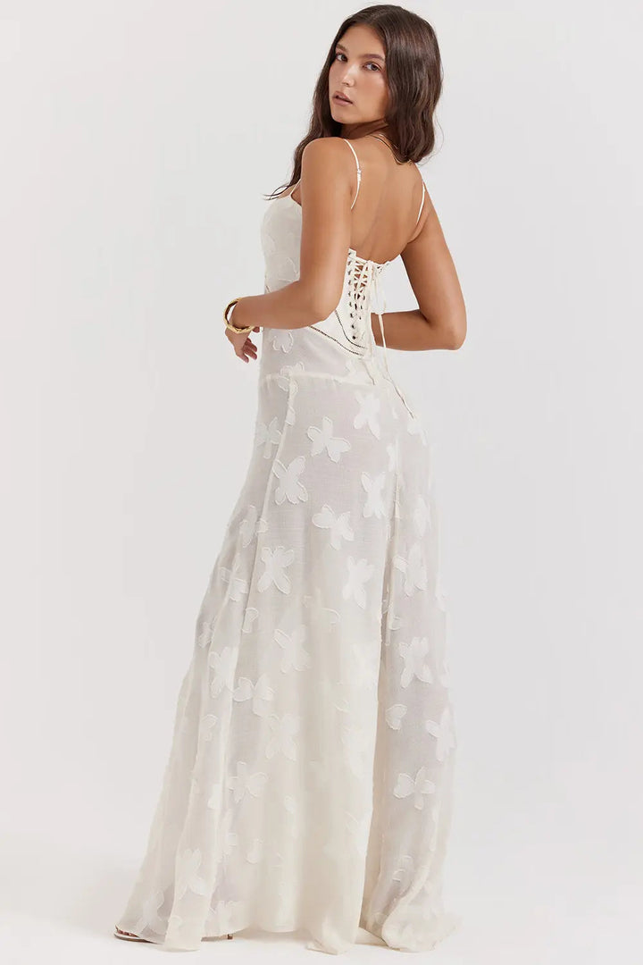 Woman wearing a white floral dress on a white background