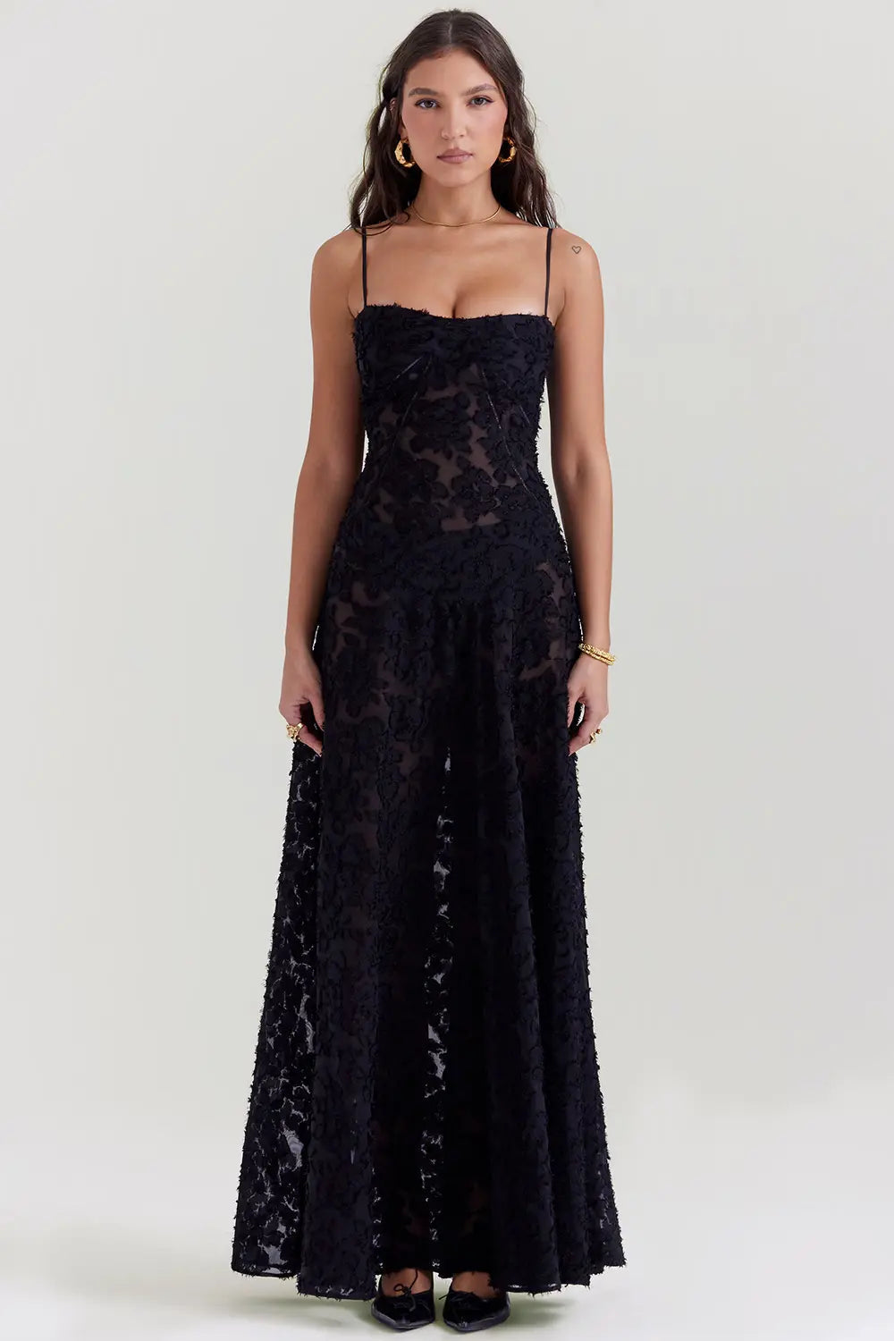 Woman wearing a black lace dress on a white background