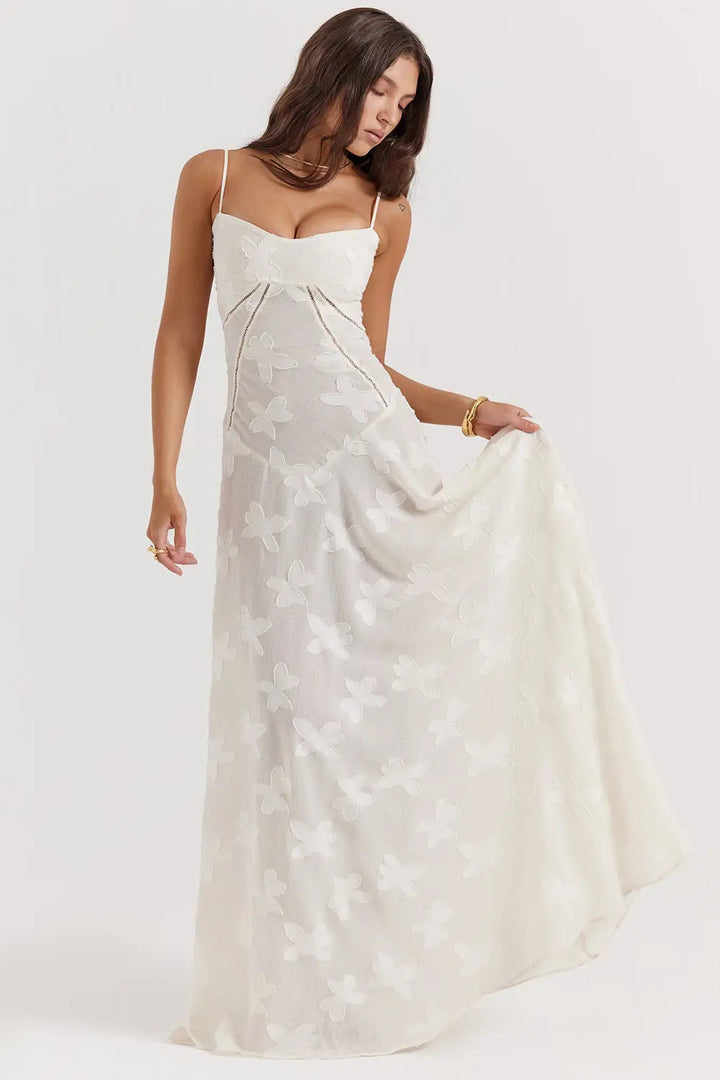 Woman wearing a white floral dress on a white background