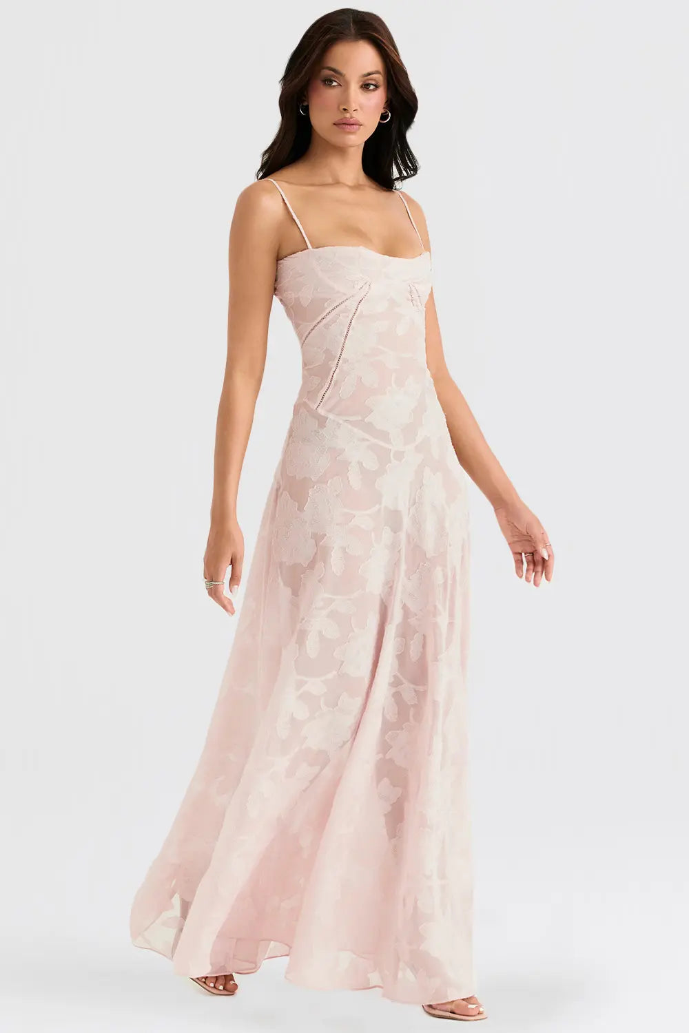 Woman wearing a pink floral dress on a white background