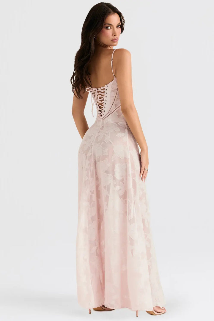 Woman wearing a pink lace-up dress on a white background