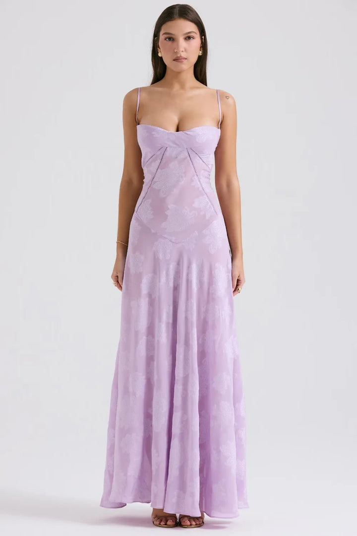 Woman wearing a long lilac dress on a white background