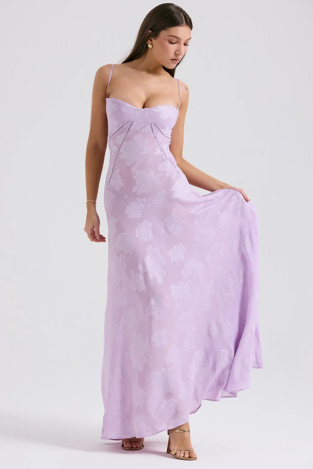 Woman wearing a light purple dress against a white background