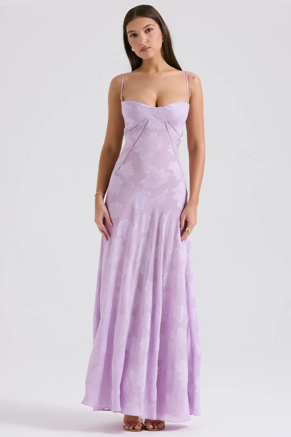 Woman wearing a purple strapless gown on a white background