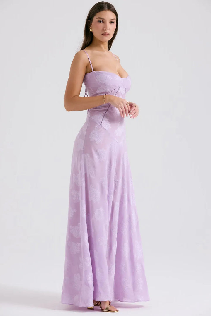 Woman wearing a lavender strapless gown on a white background