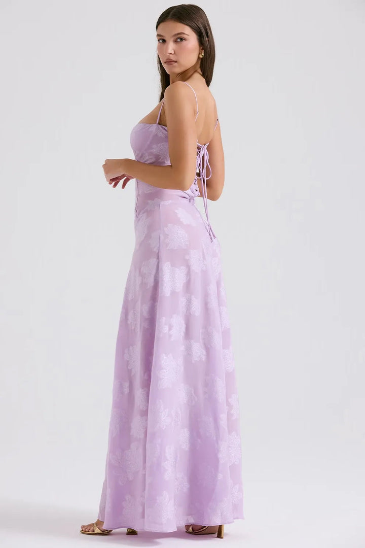 Woman wearing a strapless lavender dress with floral pattern on a white background
