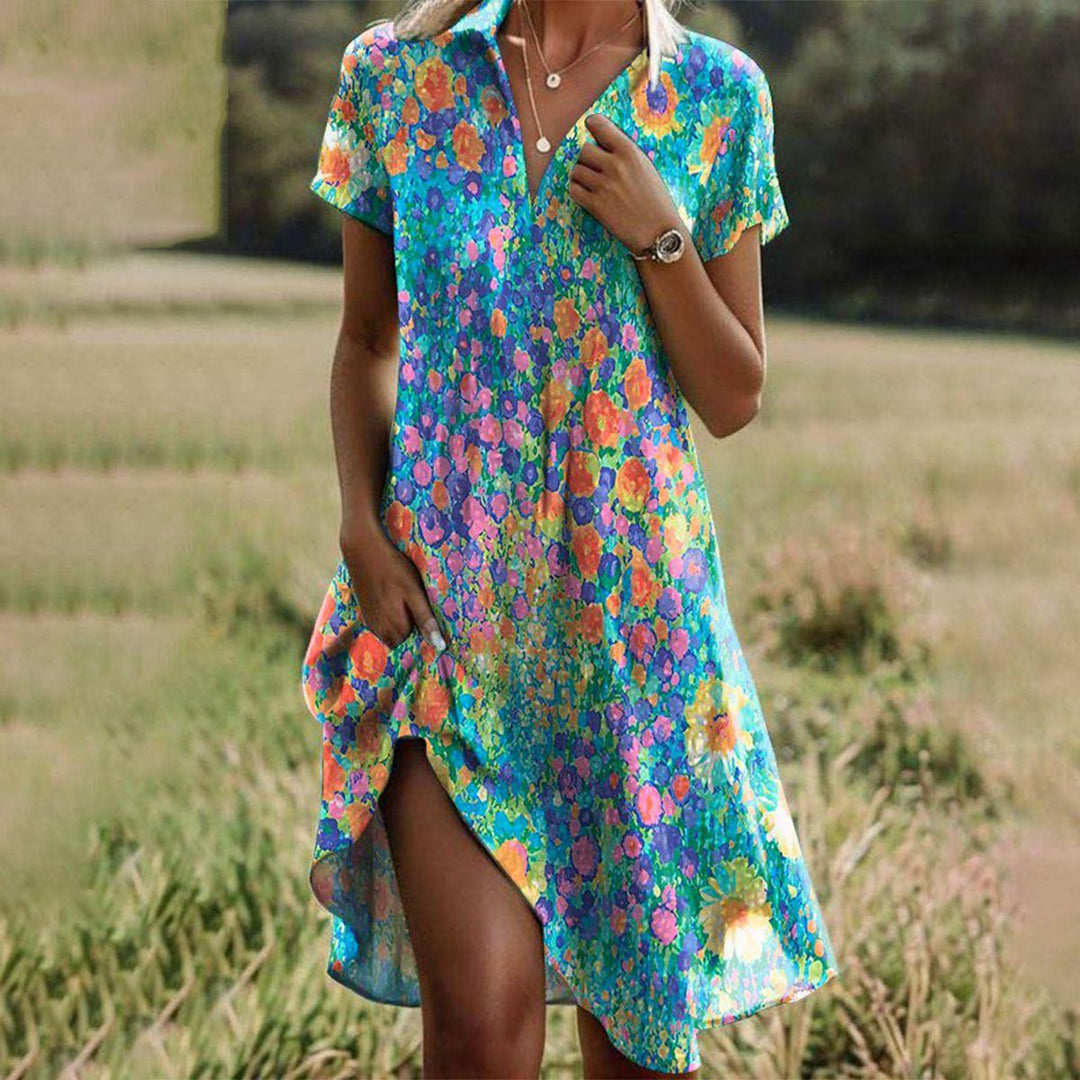 Woman wearing a colorful floral dress standing in a field