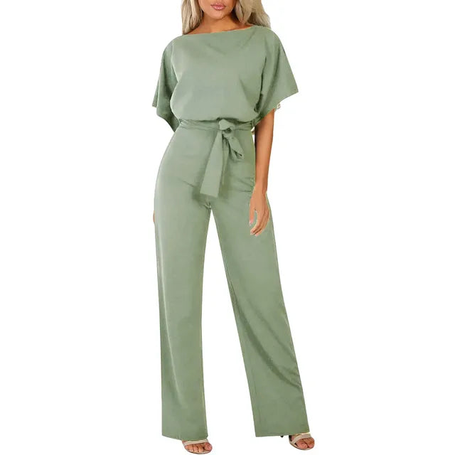 Green jumpsuit worn by a model on a white background