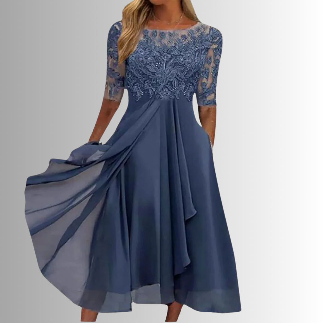 Blue lace dress with a flowing skirt on a gray background