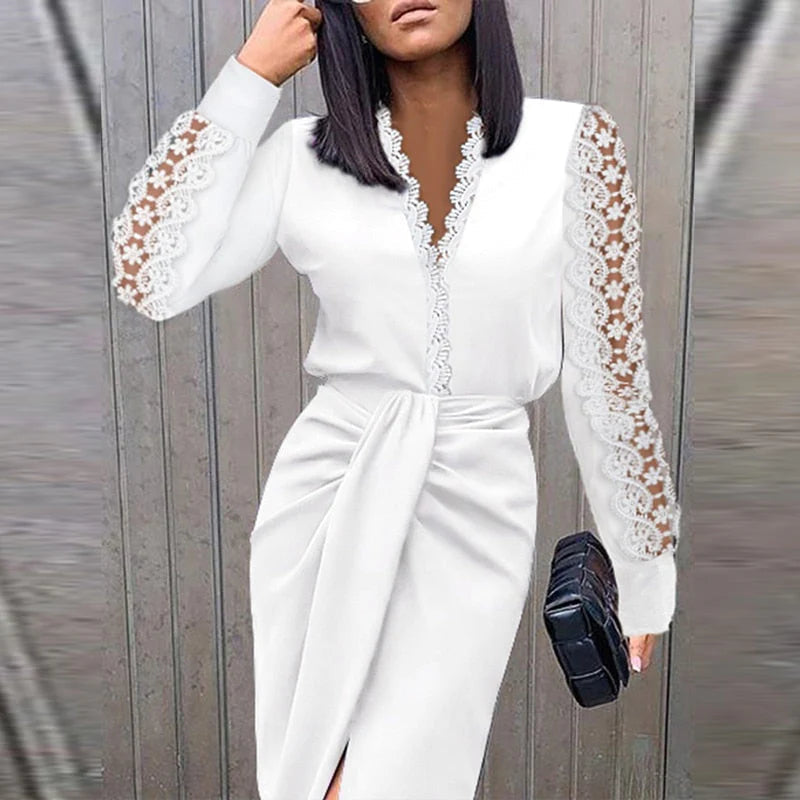 Woman wearing a white dress with lace sleeves against a gray background