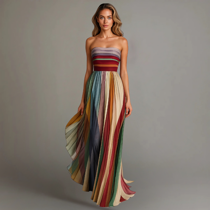 Woman wearing a strapless, multicolored dress against a gray background