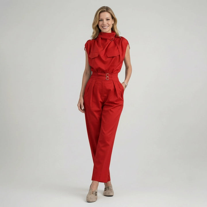 Woman wearing a red jumpsuit on a plain background
