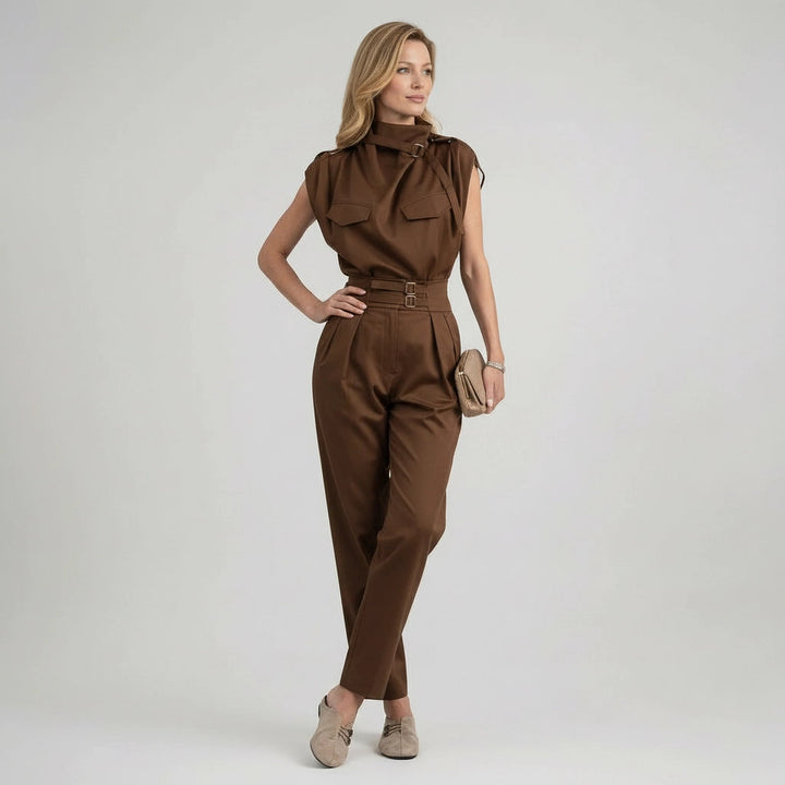 Woman wearing a brown jumpsuit on a plain background